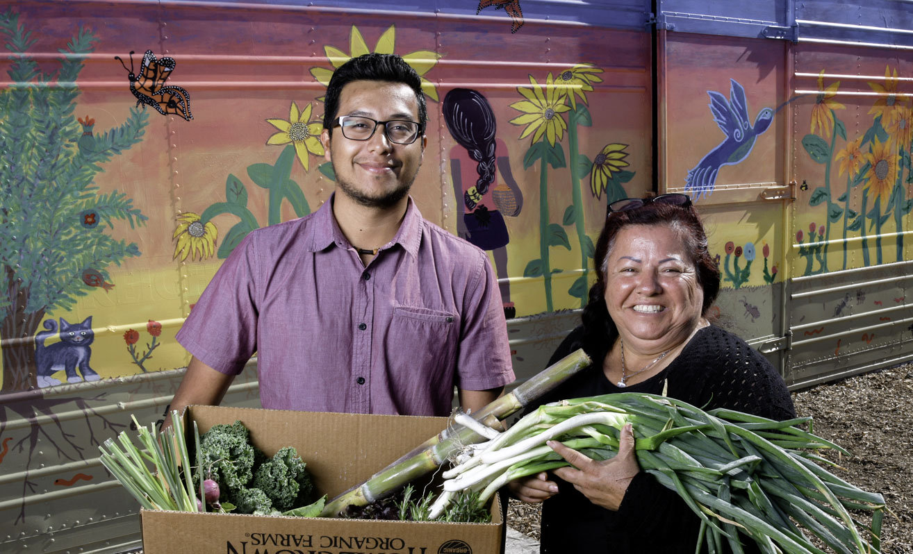 Image of man and woman holding fresh produce, courtesy of USDA.