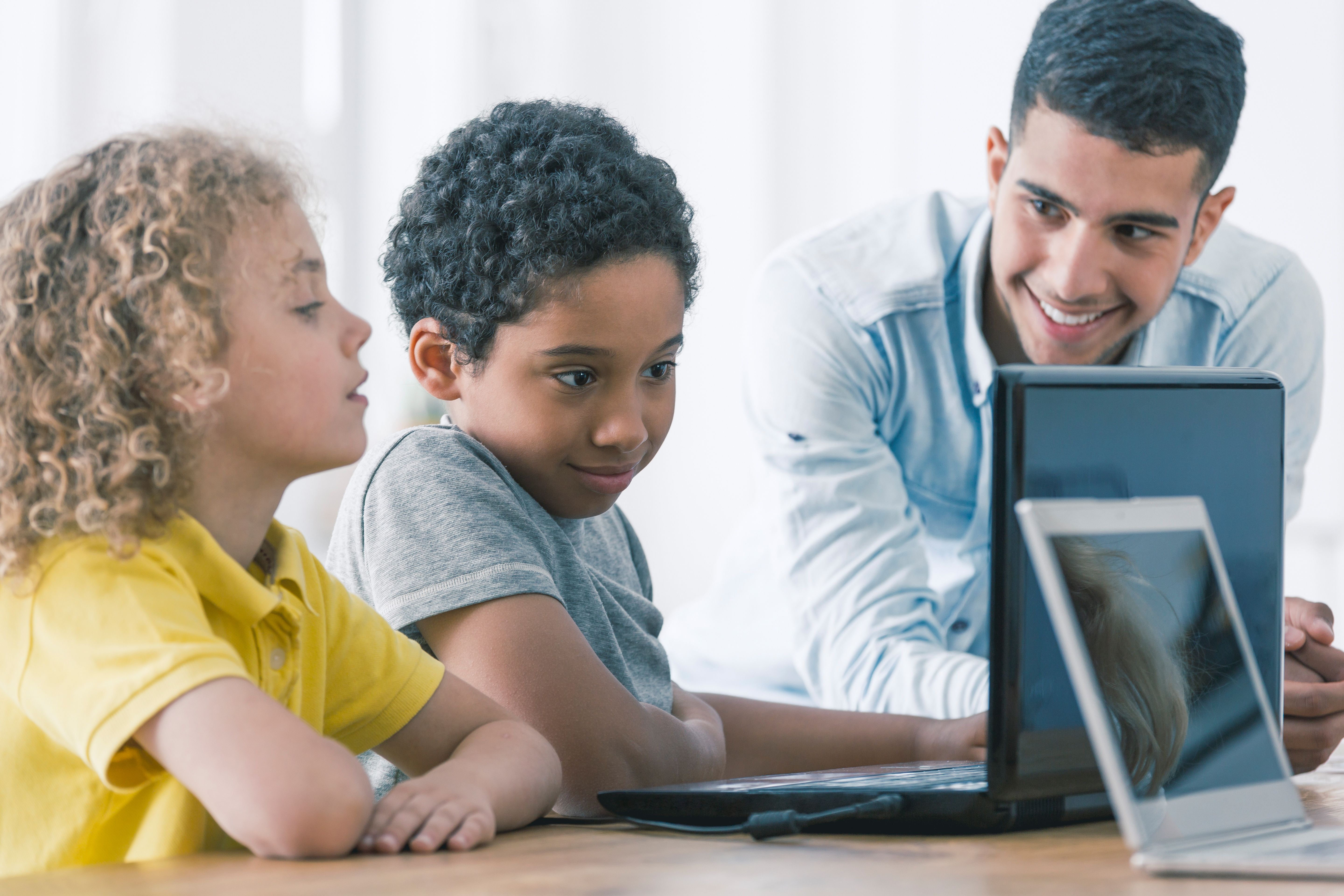 Children participating in computer coding class. Image courtesy of Adobe Stock. 