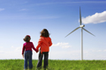 two children next to wind turbine