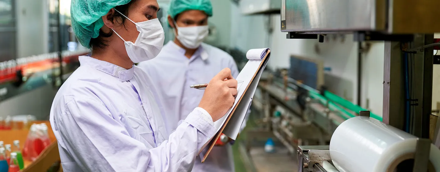 food safety worker writing on clipboard, courtesy of Adobe Stock