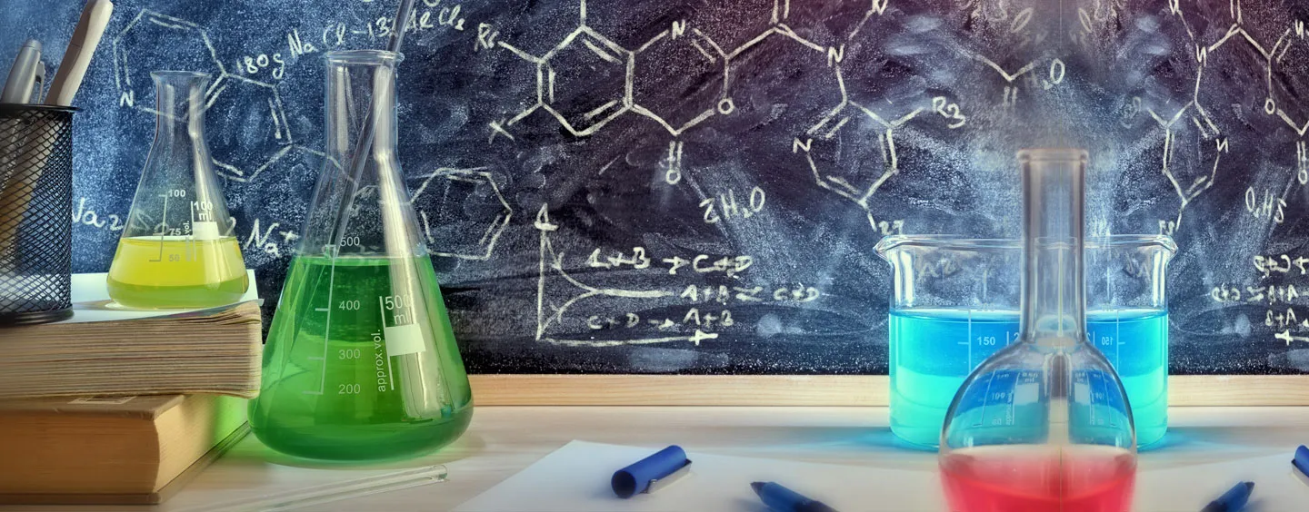 Image of beakers and blackboard with scientific writing, courtesy of Getty Images