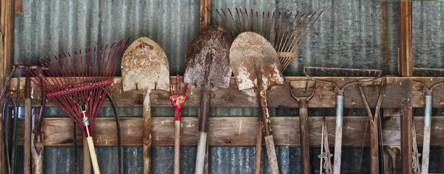 Image of garden tools hanging in barn, courtesy of Adobe Stock