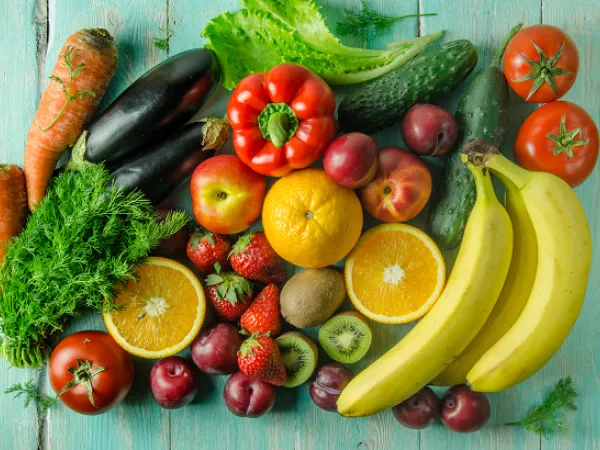 Various fruits and vegetables on a table. Image courtesy of Adobe Stock. 
