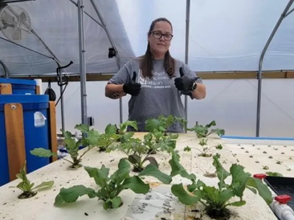 Mani Boyd, SUSHI Extension Coordinator at College of Menominee Nation (Keshena, Wisconsin), provides a tour of the SUSHI aquaponics facility.  Credit: College of Menominee Nation