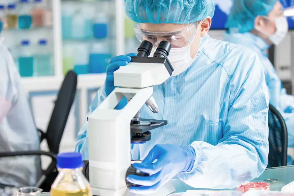 scientist studying food sample courtesy of Adobe Stock