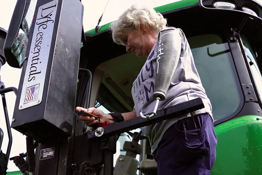 Laurie Hayn, Indiana farmer, using the assisted lift on her tractor. 