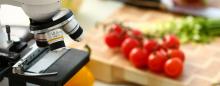 Image of microscope and table of vegetables, courtesy of Adobe Stock