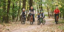 Family riding in forest, courtesy of Adobe Stock